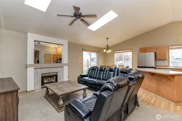 a living room with furniture a fireplace and a flat screen tv