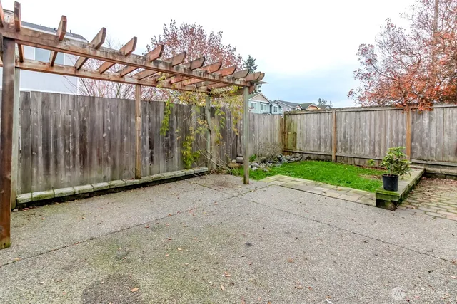 a view of a backyard with wooden fence