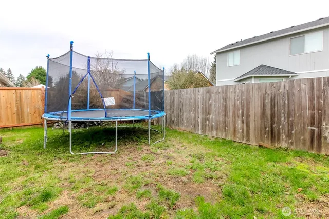 a backyard of a house with table and chairs