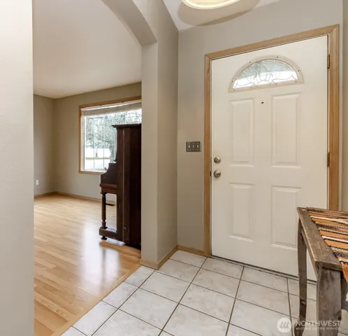 an empty room with windows and entrance