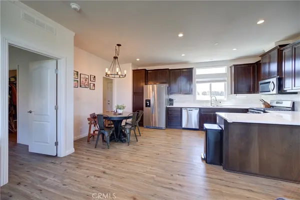 a view of kitchen with cabinets and wooden floor