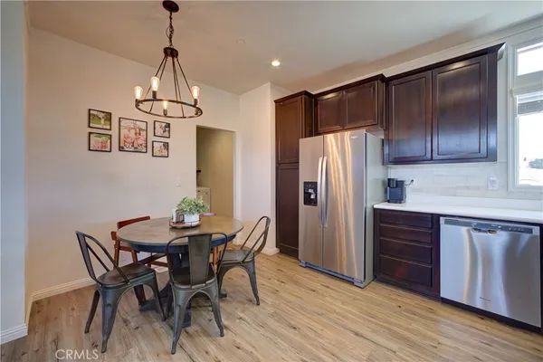 a view of a dining room with furniture wooden floor and chandelier