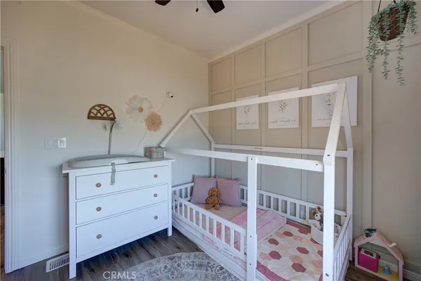 a front view of a bedroom with baby crib