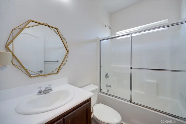 a bathroom with a sink toilet and a mirror