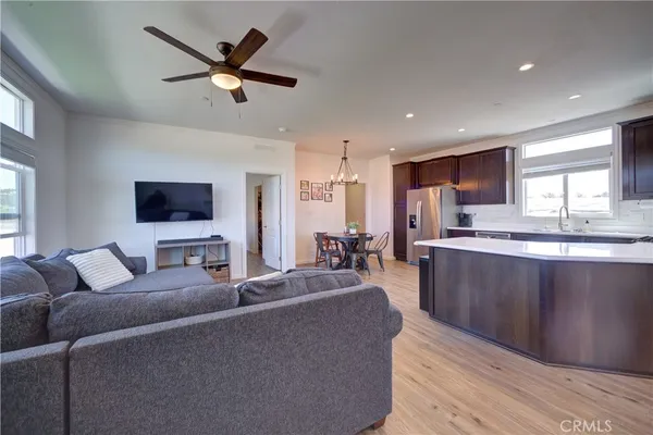 a living room with furniture a window and a flat screen tv