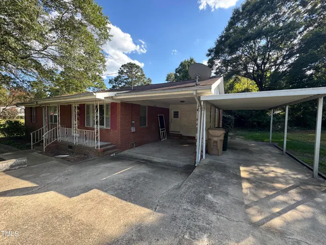 a view of a house with a backyard and porch