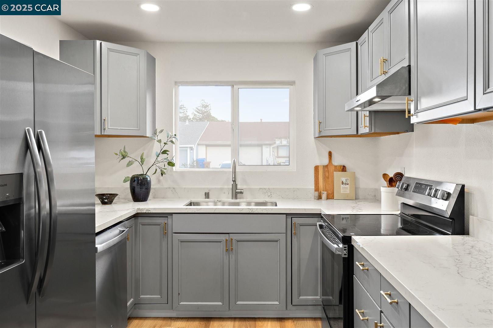3575 Desanie Circle Bay Point, CA 94565 - Photo 8 of 37 a kitchen with stainless steel appliances a sink a stove a refrigerator and cabinets