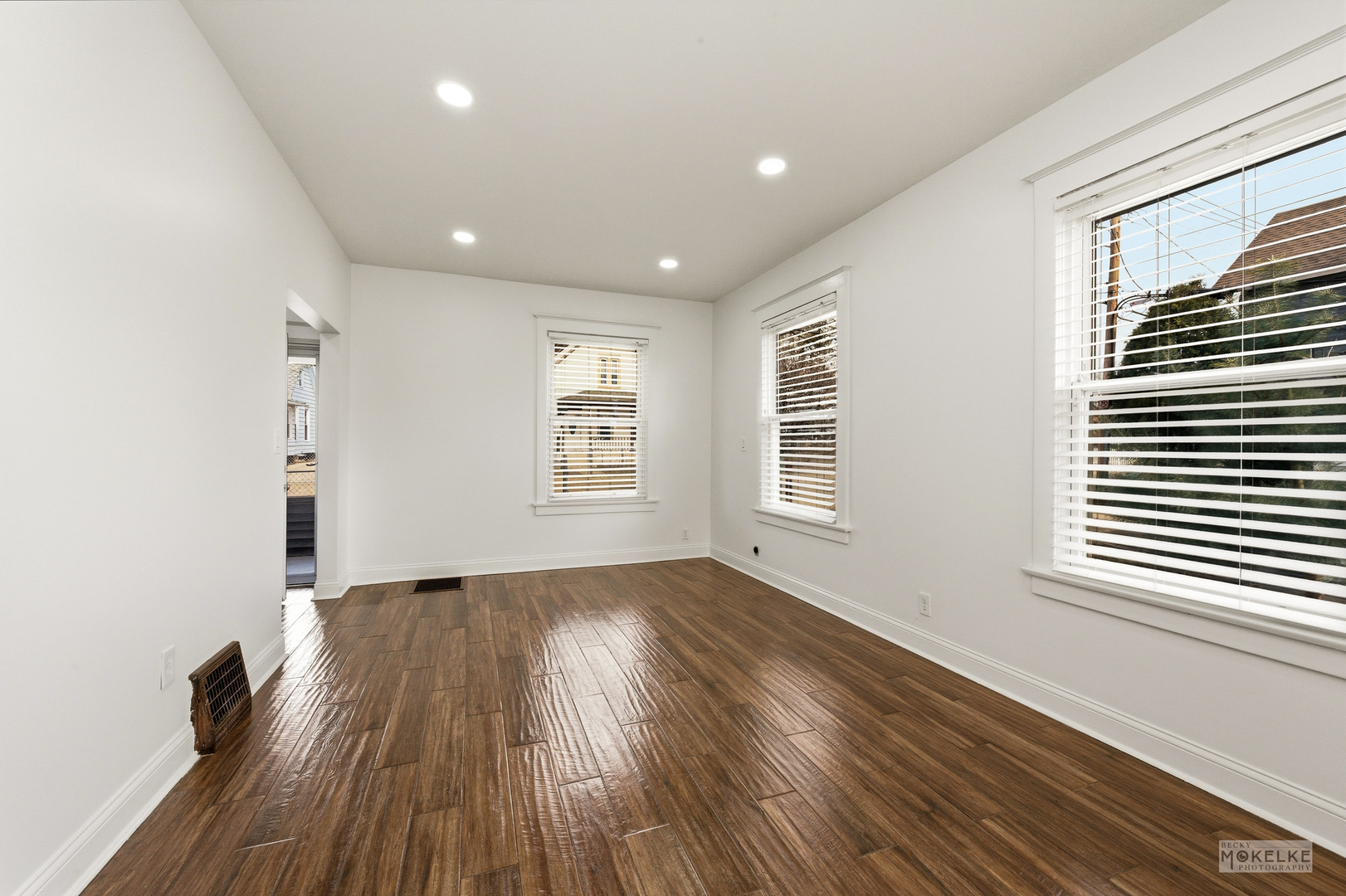 363 Franklin Boulevard Elgin, IL 60120 - Photo 6 of 32 an empty room with wooden floor and windows