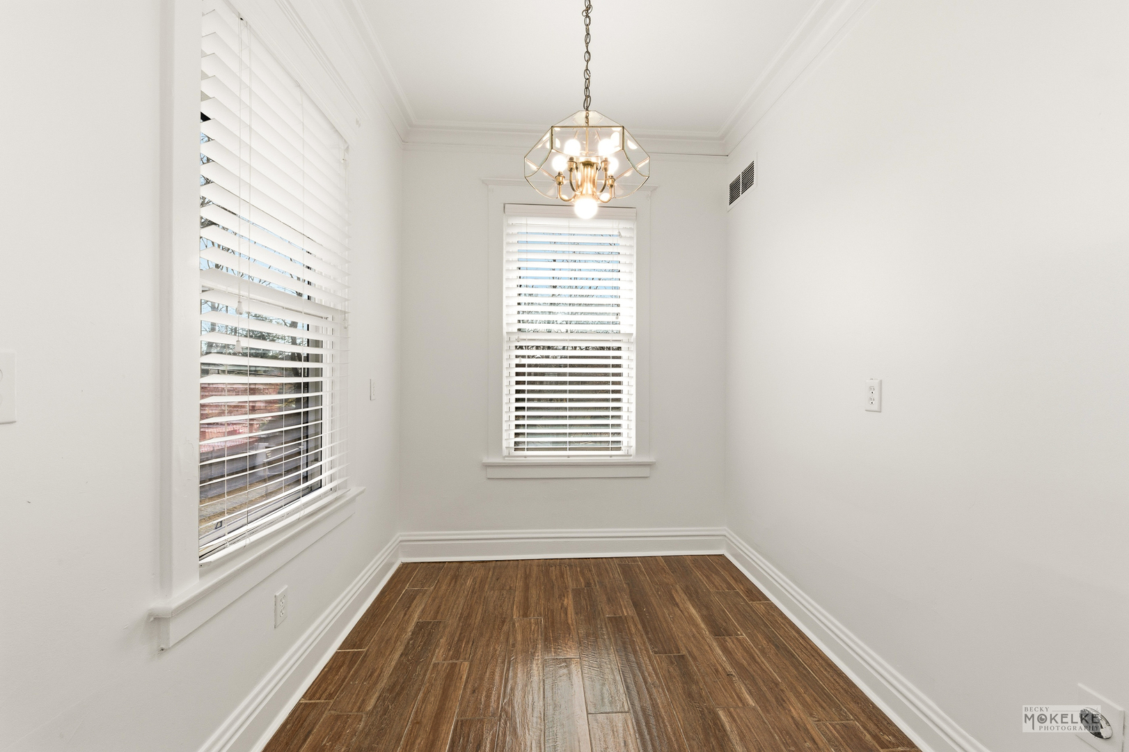 363 Franklin Boulevard Elgin, IL 60120 - Photo 8 of 32 a view of an empty room with wooden floor and a window