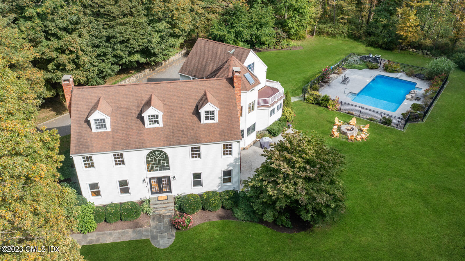 an aerial view of a house with outdoor space pool seating area and yard