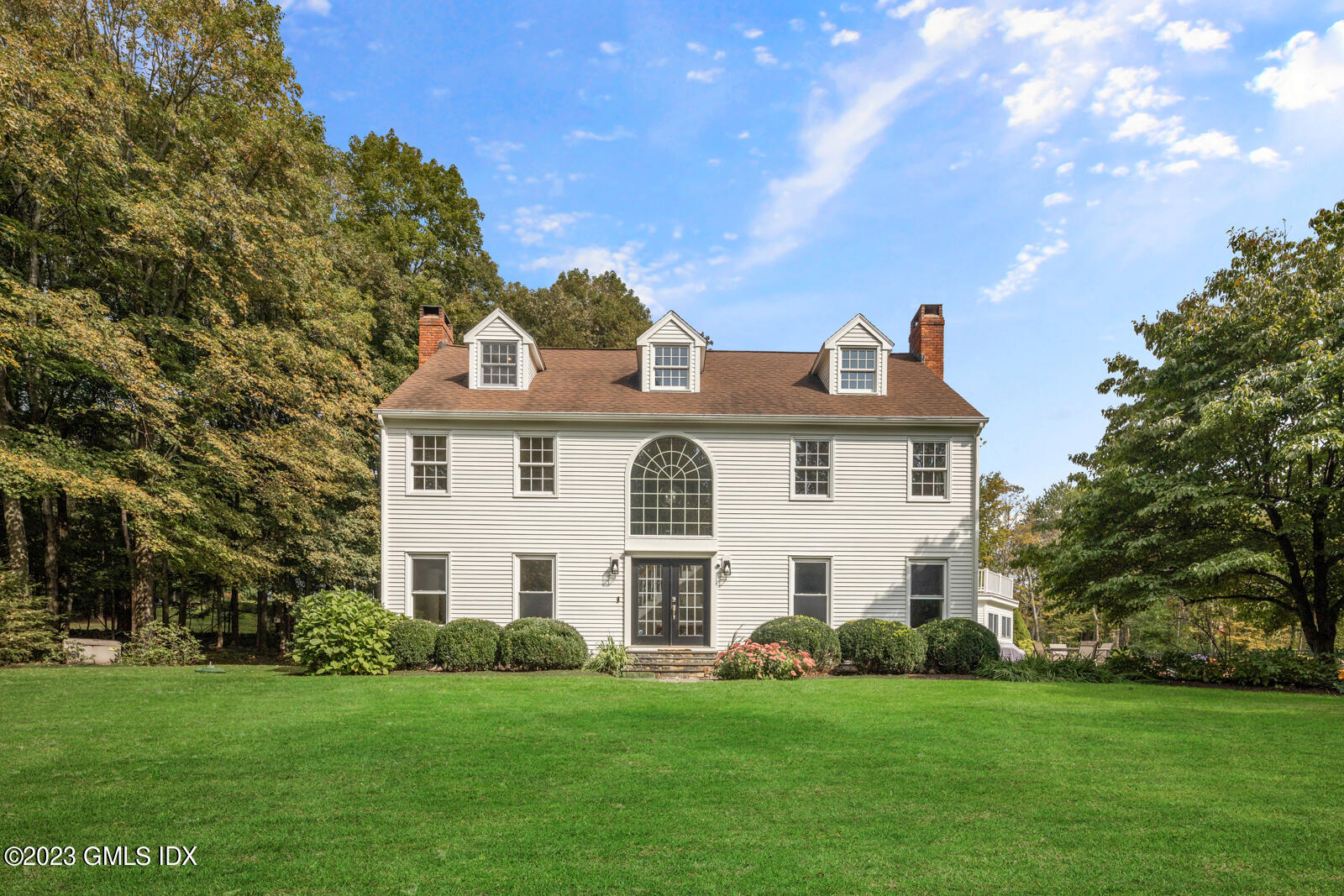22 Drummer Lane Redding, CT 06896 - Photo 2 of 40 a front view of a house with a garden