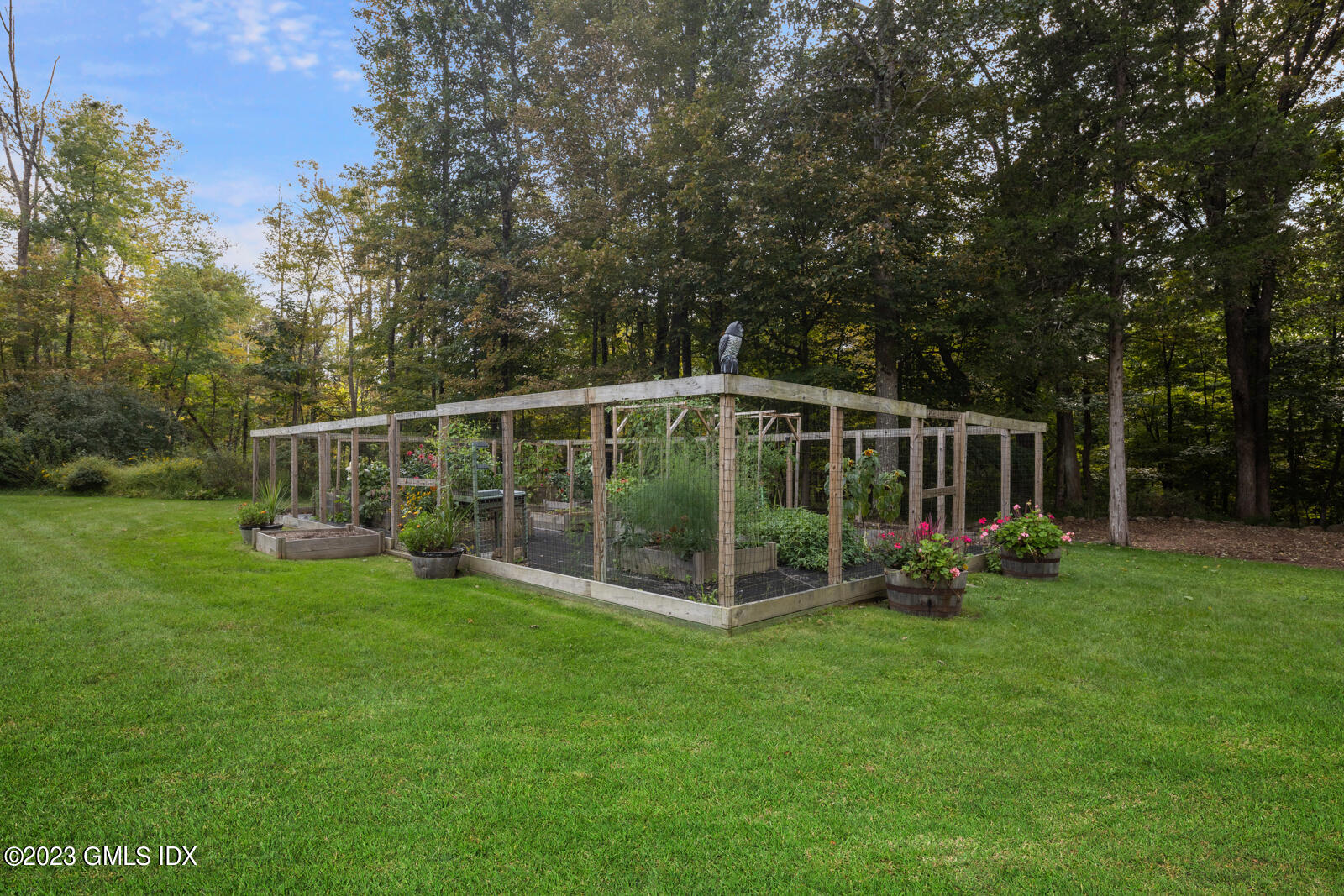 22 Drummer Lane Redding, CT 06896 - Photo 30 of 40 a view of a deck with a big yard and potted plants and large trees