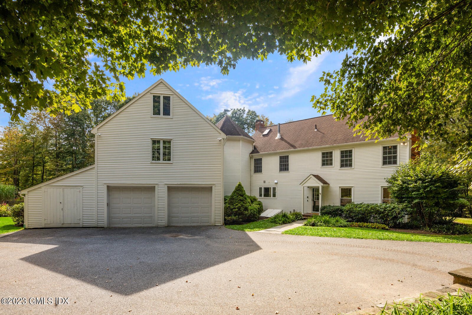 22 Drummer Lane Redding, CT 06896 - Photo 32 of 40 a view of a white house with a yard and large tree