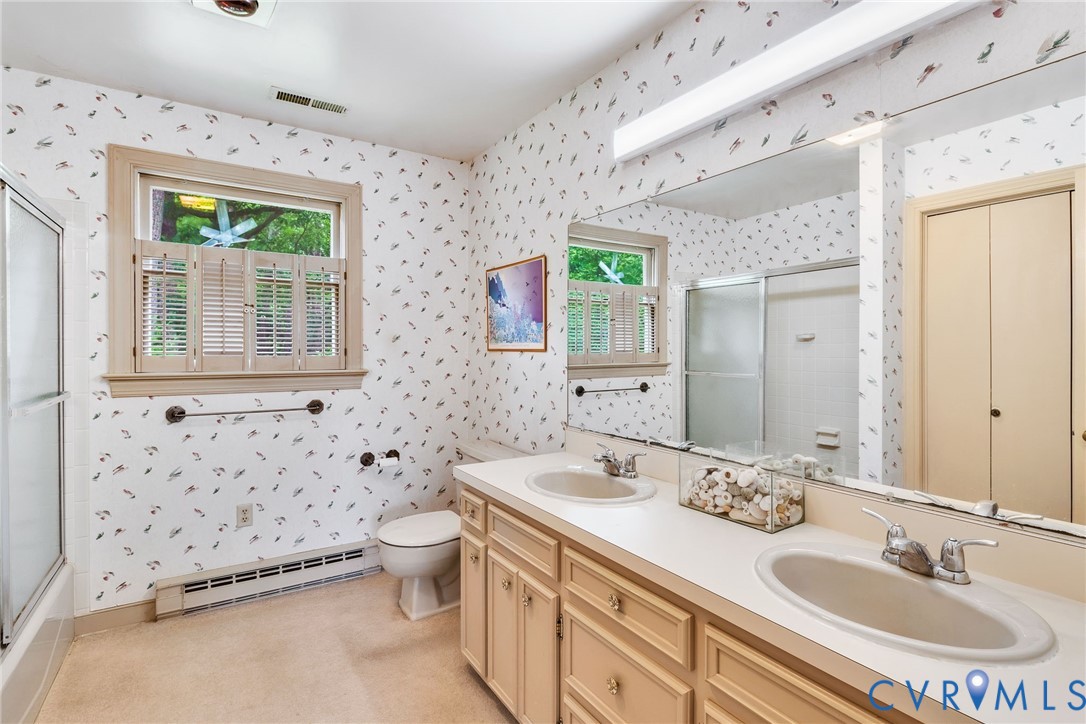 142 Bridge Lane Reedville, VA 22539 - Photo 12 of 56 a bathroom with 2 sink toilet and a mirror