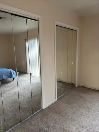 a view of an empty room with a mirror