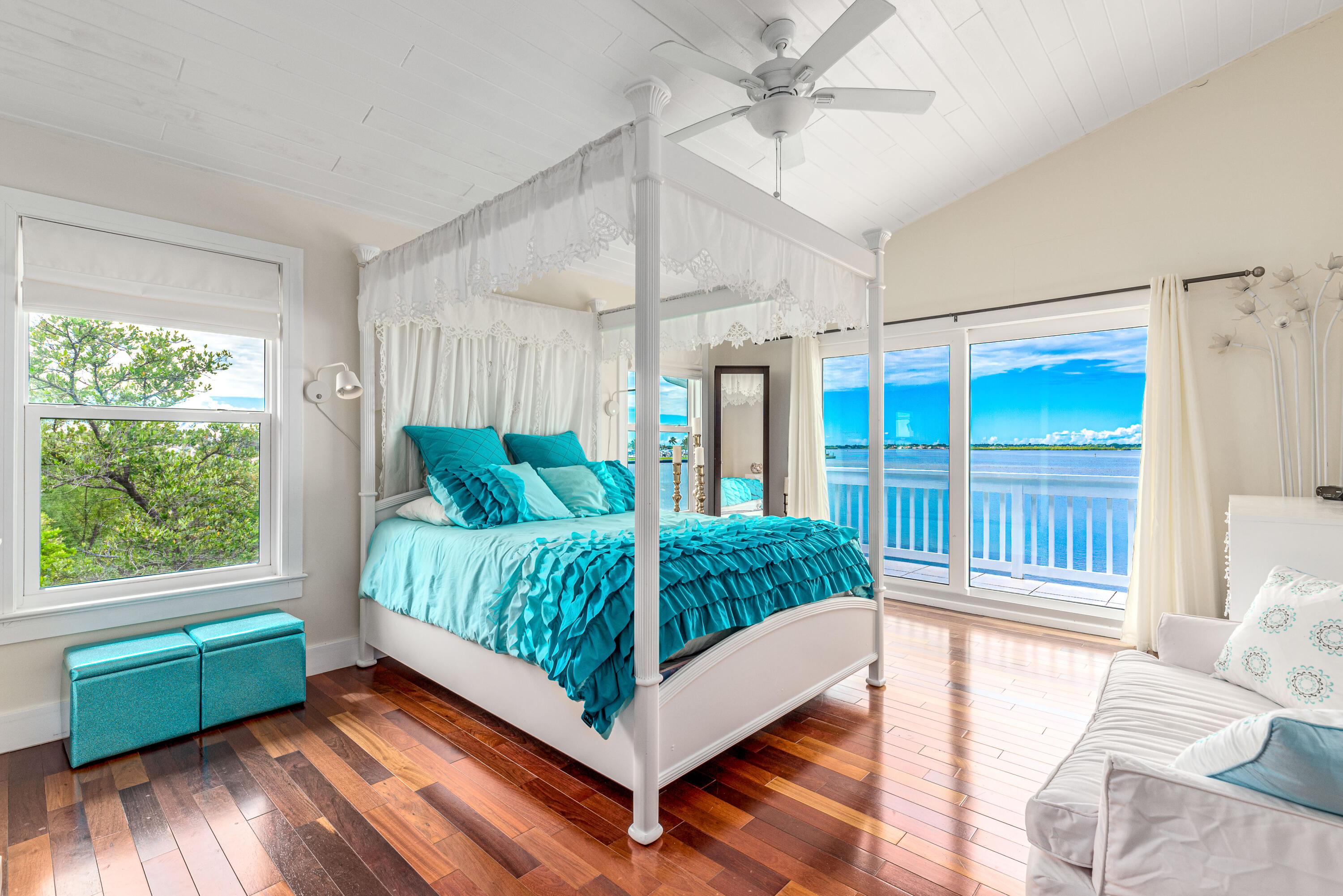 1470 Southeast MacArthur Boulevard Stuart, FL 34996 - Photo 13 of 15 a bed sitting in a bedroom next to a window