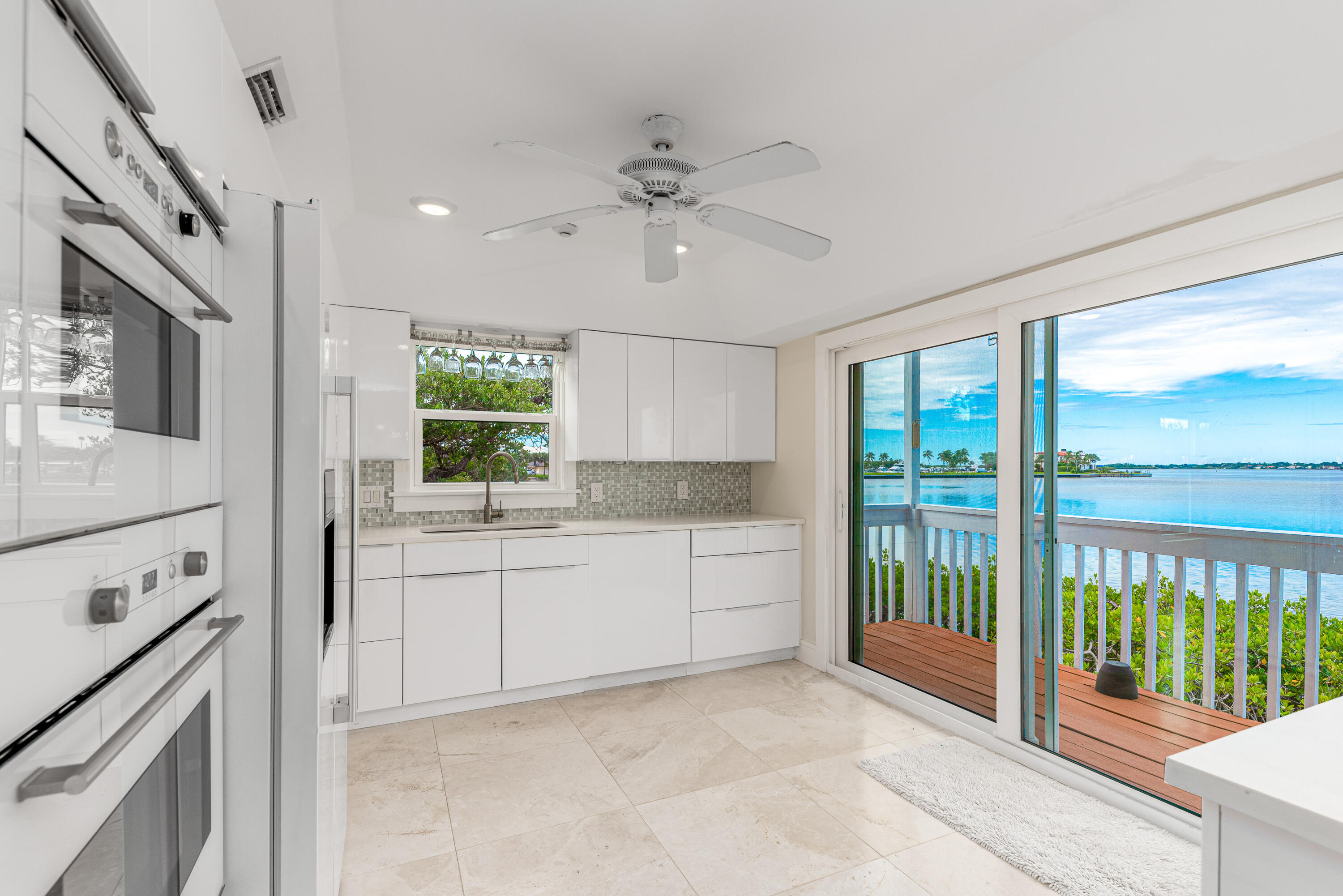 1470 Southeast MacArthur Boulevard Stuart, FL 34996 - Photo 5 of 15 a kitchen with granite countertop a stove a sink and a refrigerator