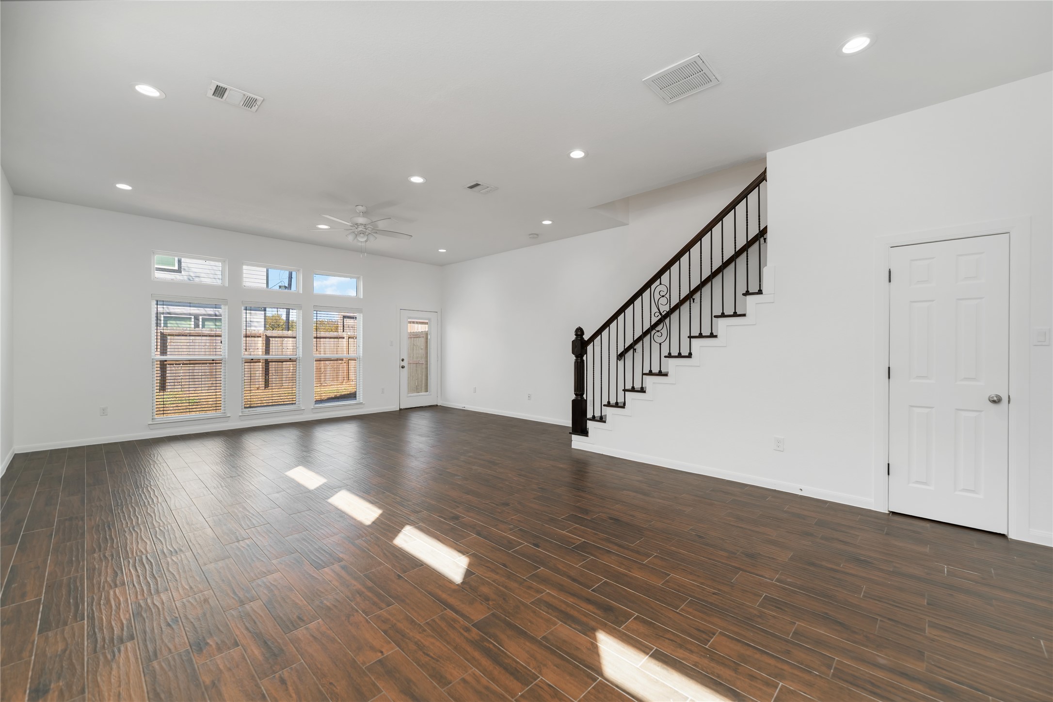 7902 Parnell Street, Unit B Houston, TX 77051 - Photo 6 of 13 a view of an empty room with wooden floor and staircase