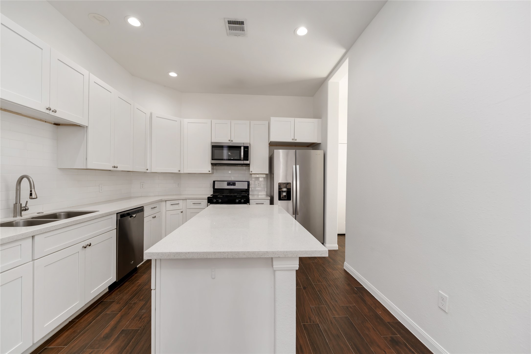 7902 Parnell Street, Unit B Houston, TX 77051 - Photo 8 of 13 a kitchen with kitchen island a sink appliances and cabinets