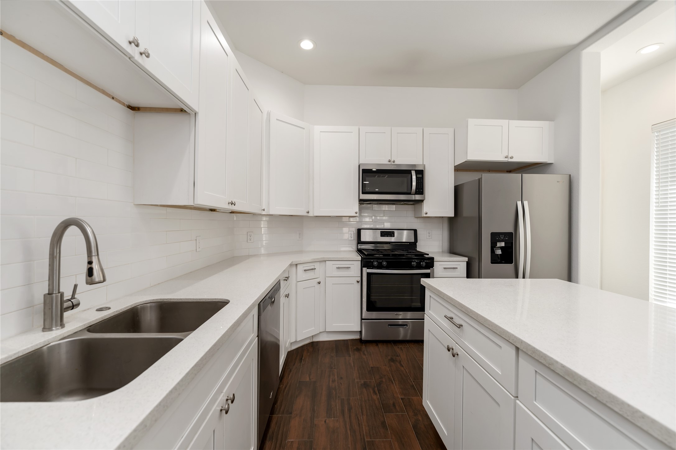 7902 Parnell Street, Unit B Houston, TX 77051 - Photo 9 of 13 a kitchen with a sink cabinets and stainless steel appliances