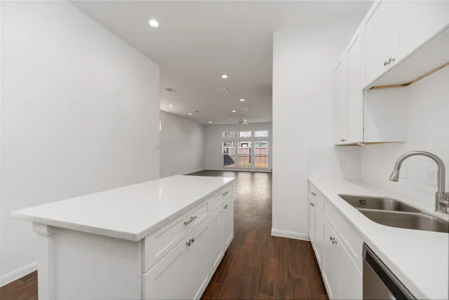 a kitchen with a sink a stove and cabinets