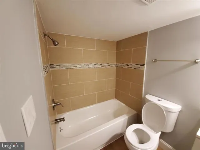 a bathroom with a toilet and shower
