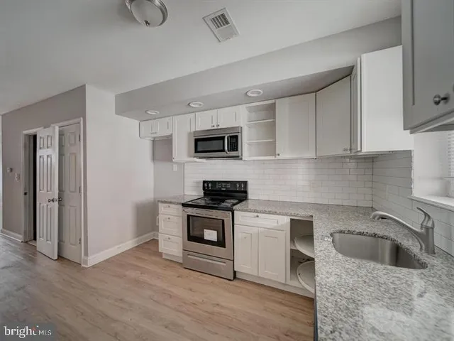 a kitchen with stainless steel appliances a refrigerator stove and microwave