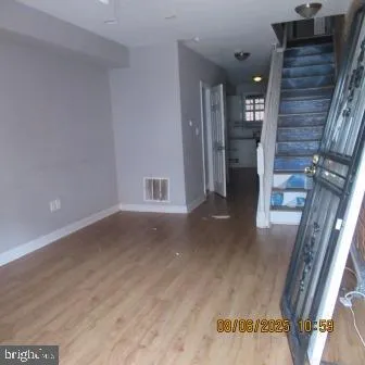 a view of staircase with railing and white walls