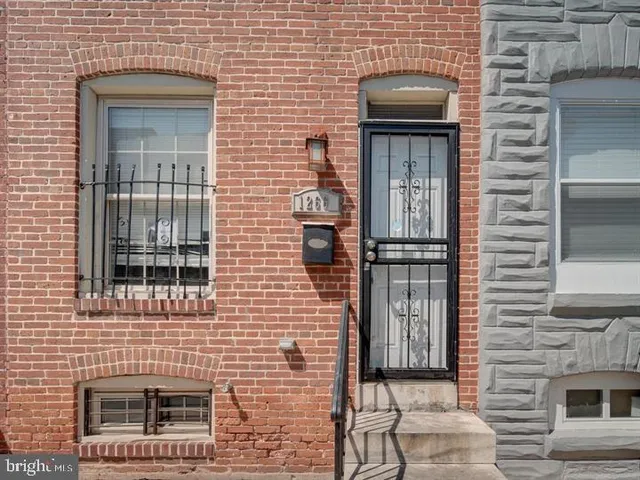 a brick house with a door and a window