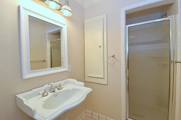 a bathroom with a sink a mirror and a shower