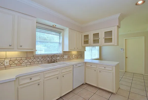 a kitchen with a sink stove and cabinets