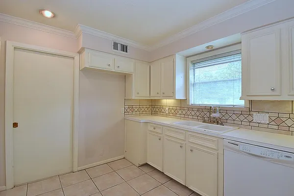 a kitchen with a sink cabinets and window