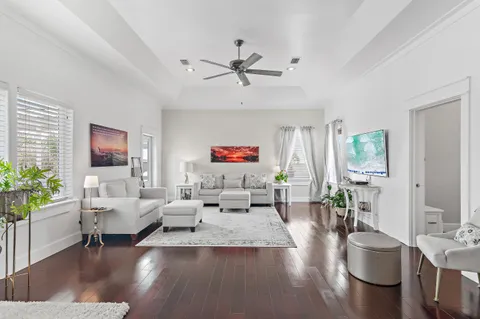 a living room with furniture ceiling fan and a window