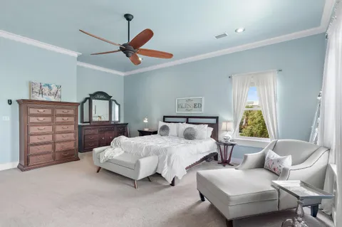 a bedroom with furniture and a chandelier