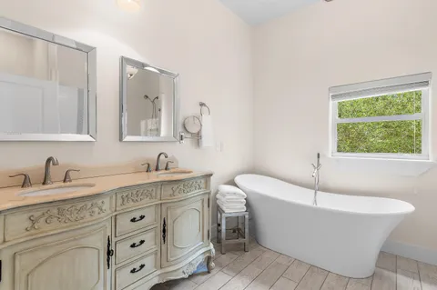 a bathroom with a bathtub sink and mirror