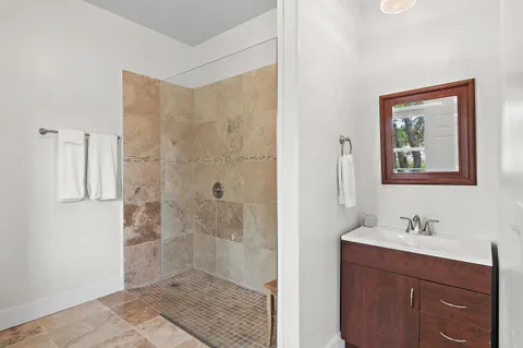 a bathroom with a shower sink and mirror