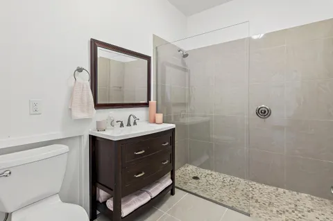 a bathroom with a sink toilet and shower