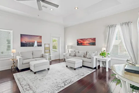 a living room with furniture and a wooden floor