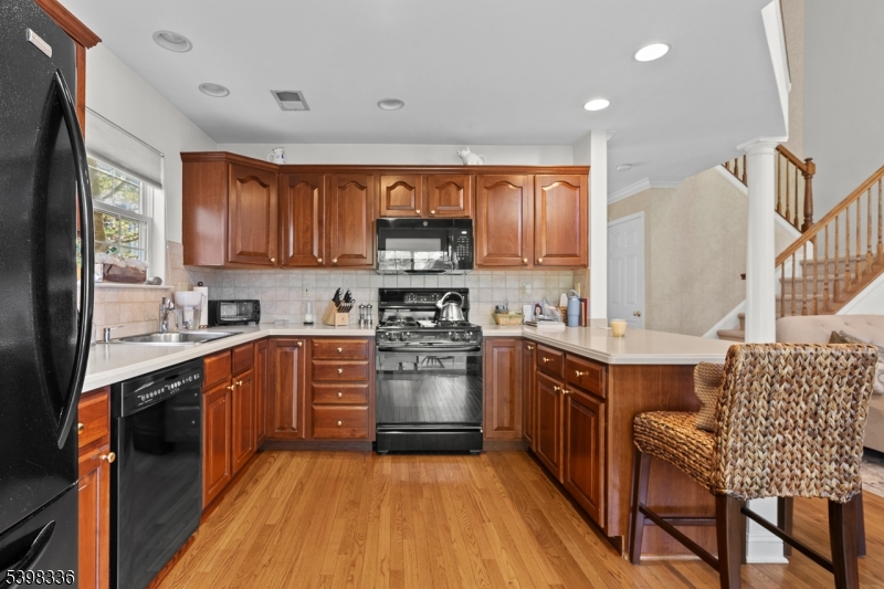 14 Minuteman Court Bernards, NJ 07920 - Photo 11 of 34 a large kitchen with stainless steel appliances granite countertop a stove a sink dishwasher and a refrigerator