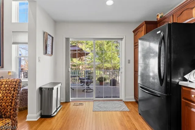 a kitchen with granite countertop a refrigerator and a stove top oven