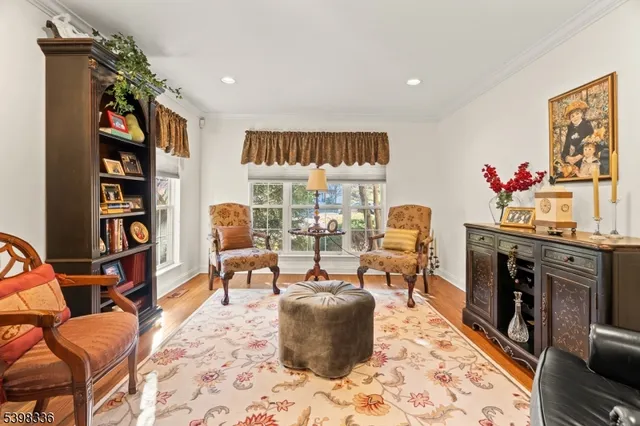 a living room with furniture and a book shelf