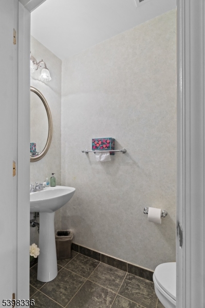 14 Minuteman Court Bernards, NJ 07920 - Photo 16 of 34 a bathroom with a sink a toilet and a mirror