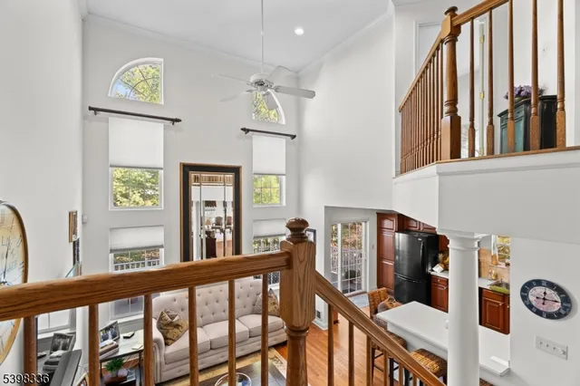 a view of a hallway with wooden floor and windows