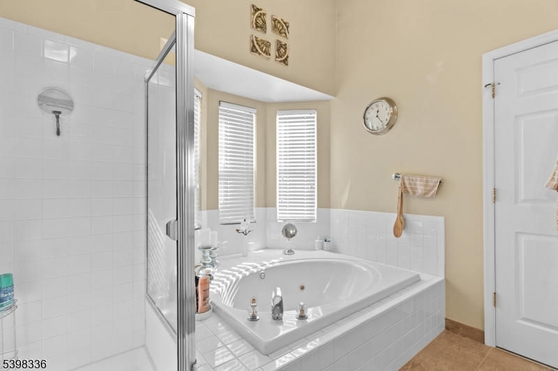 14 Minuteman Court Bernards, NJ 07920 - Photo 21 of 34 a bathroom with a bathtub and a shower