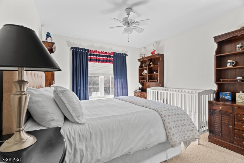 14 Minuteman Court Bernards, NJ 07920 - Photo 23 of 34 a bed sitting in a bedroom next to a window