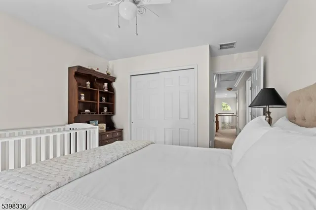 a bedroom with a large bed and a book shelf
