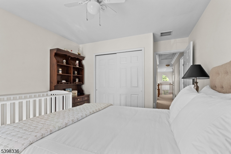 14 Minuteman Court Bernards, NJ 07920 - Photo 24 of 34 a bedroom with a large bed and a book shelf