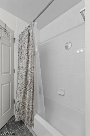 a bathroom with a shower curtain and a shower curtain