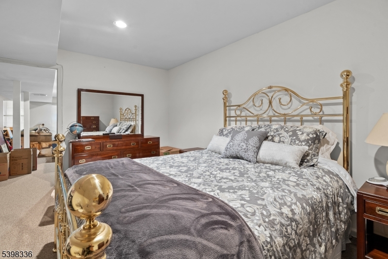 14 Minuteman Court Bernards, NJ 07920 - Photo 29 of 34 a bedroom with a bed and a mirror on dresser