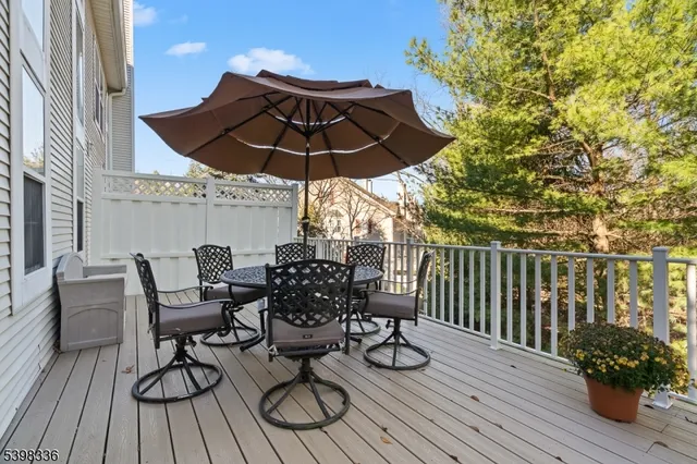 a view of balcony with wooden floor and outdoor seating
